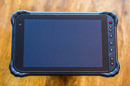 A MINNO Android tablet displayed on a wooden background.