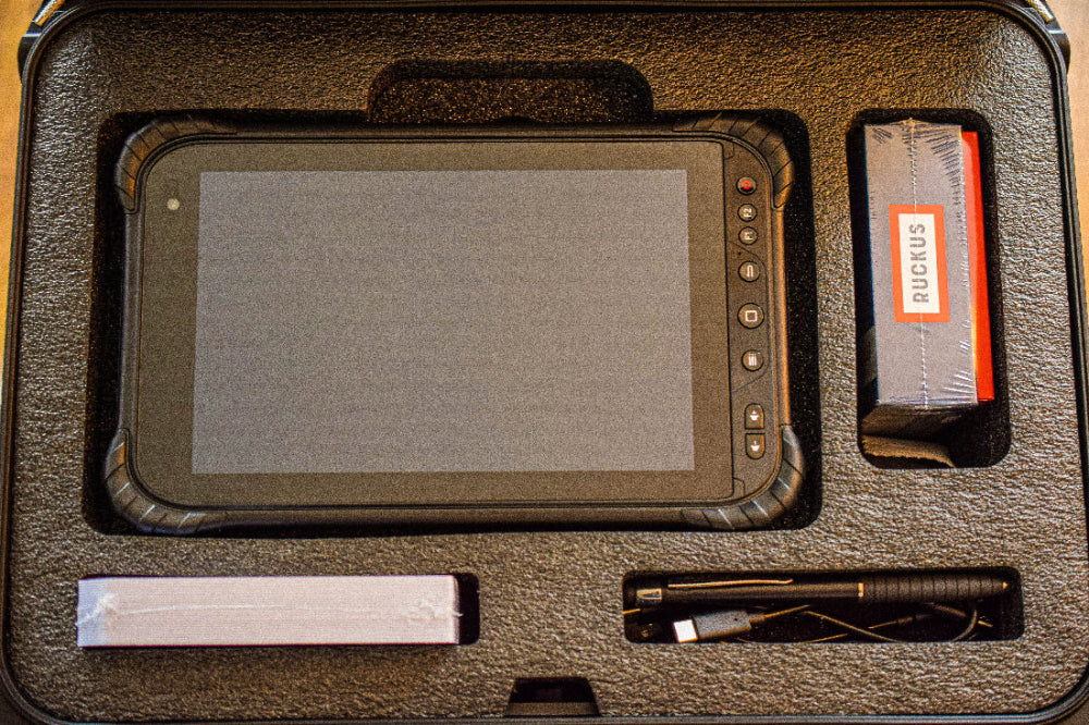 Inside a NANUK hard case are he accessories included with a PROSARIS OL2 Pro Kit, such as a tablet, headphones, cords, and Smart Tags.