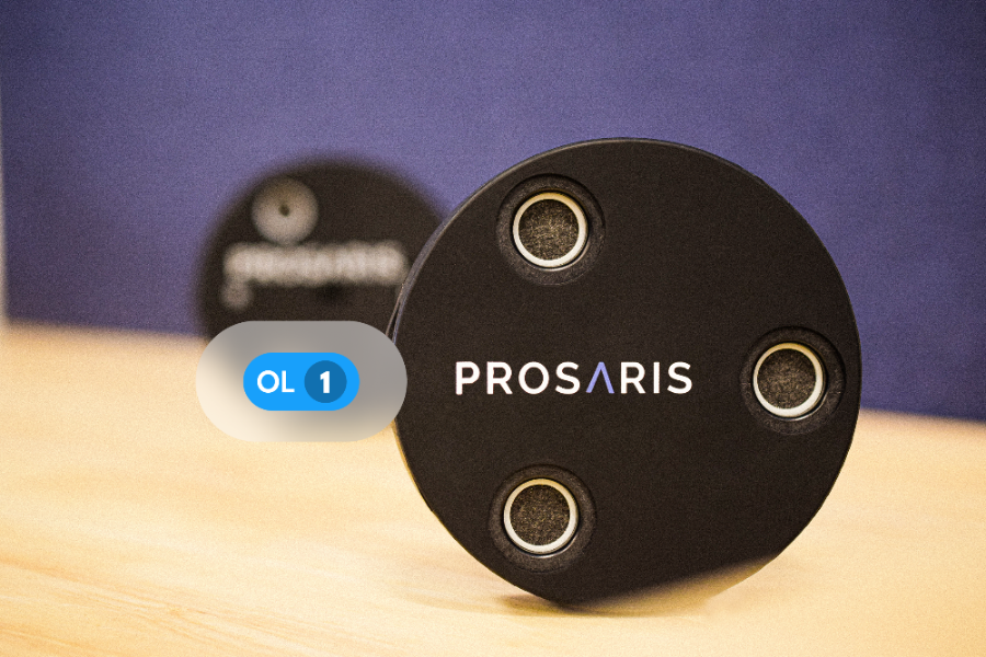 A PROSARIS OL1 ultrasonic device is in frame. Another PROSARIS device can be seen behind it. The text "OL1" is overlaid on a blue tag on top of the OL1 device.