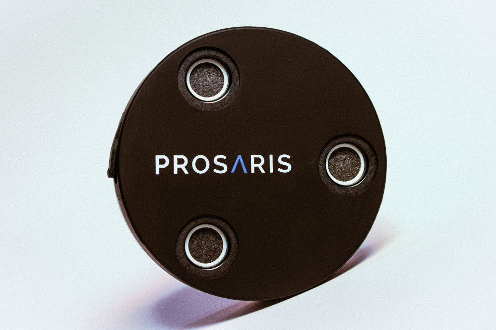 A PROSARIS OL1 ultrasonic sensor &quot;Puck&quot; in front of a white background.