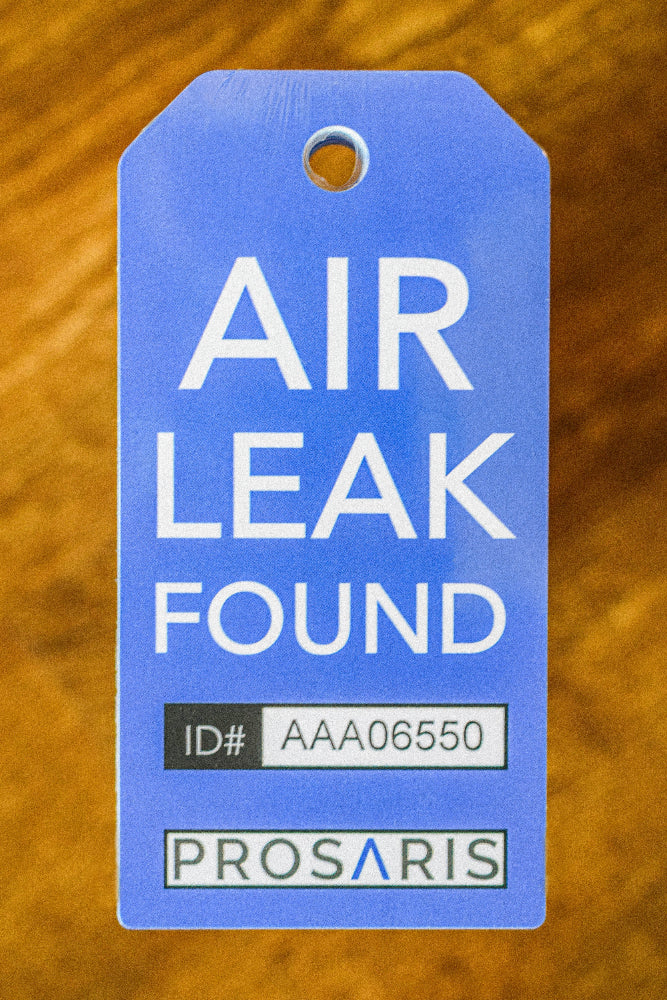 A PROSARIS Smart Tag on a wooden backdrop.